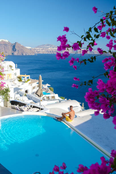 Couple on vacation in Santorini Greece, men and women visit the whitewashed Greek village of Oia stock photo