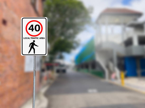 Speed limit Warning sign of Local traffic area with speed limit 40 km per hour on local area with defocus background. Australian regulatory law sign and safety concept. speed limit sign australia stock pictures, royalty-free photos & images