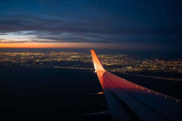 istock Flying into Large City During Colorful Sunset 1471335417