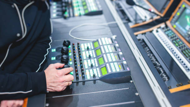 istock View of lighting technician operator working on mixing console workplace during live event concert on stage show broadcast, light mixer controller panel, sound technician with professional equipment 1471335426