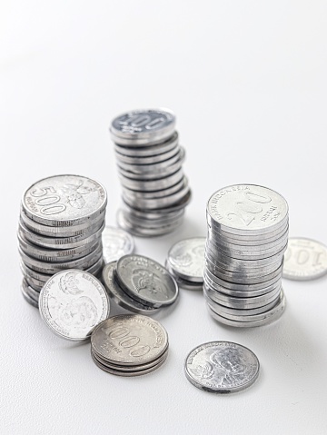 Podium - Coins piled up displaying a growing chart isolated on a white background
