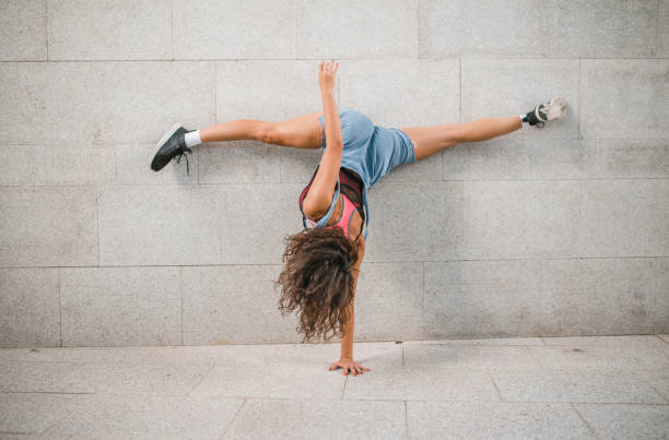 istock A woman does a handstand with her legs spread in a split 1471344013