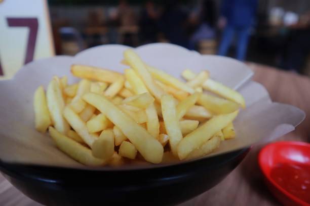 istock French fries or potato chips with ketchup on the table. 1471345674