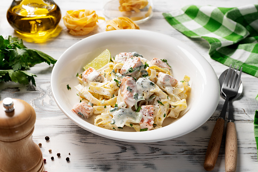Italian made fettuccine pasta with creamy sauce and grilled salmon.
