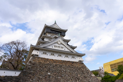 Kitakyushu, Japan - Dec 29,2022 : White tower of Kokura castle with blue sky in Kitakyushu, Japan on Dec 29,2022.