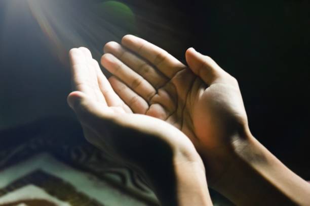 istock the hands of someone who is raising both hands in prayer 1471353340