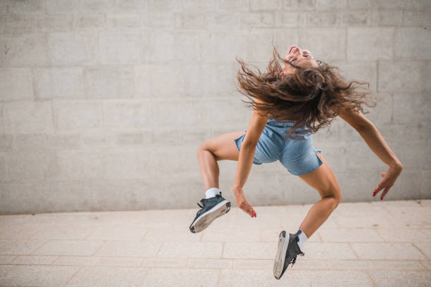 istock Happy dancer with curly hair enjoying her dance moves 1471354541