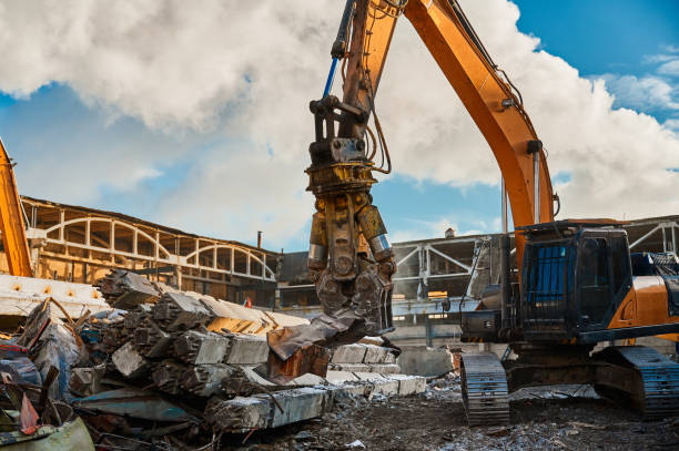 istock Excavator with hydraulic scissors cuts concrete beams 1471355445