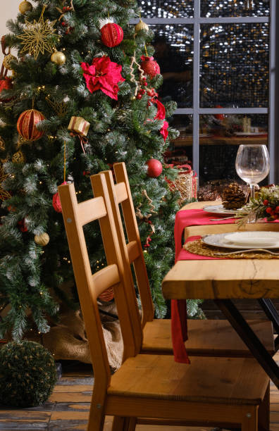 istock wooden table with chairs and a Christmas tree decorated with balls 1471356795