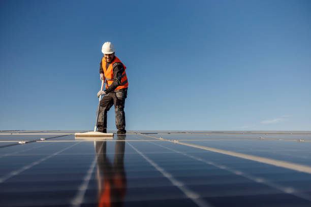 istock A worker is cleaning solar panels from dust. 1471358418