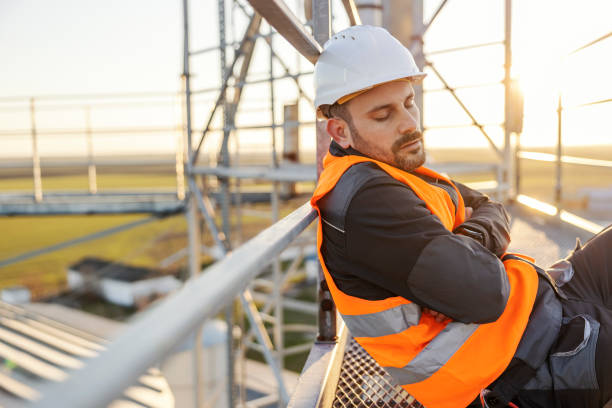 istock A sleepy height works worker is sleeping on metal construction. 1471358886