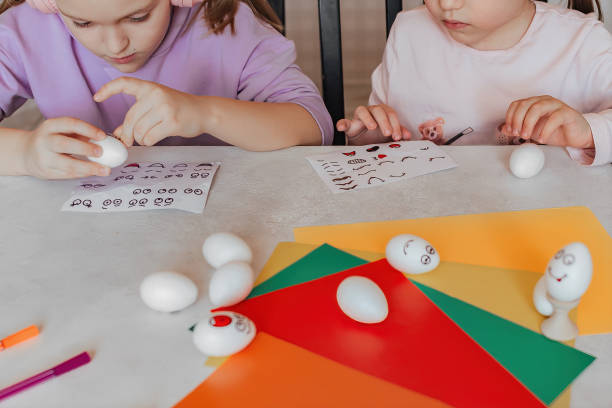 istock Two sisters at home at the table stick stickers on eggs 1471360384