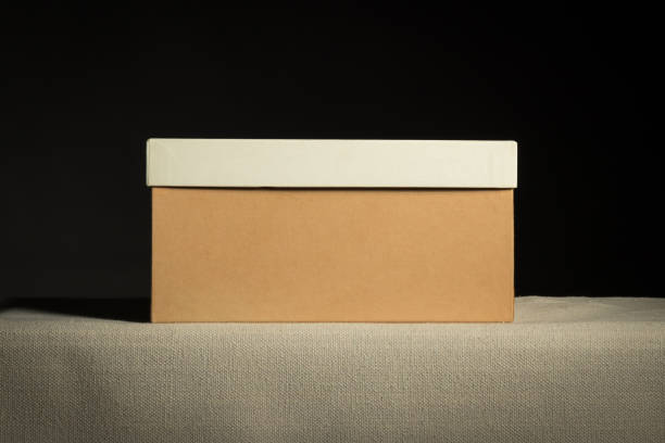 istock Front view on closed brown cardboard box on black background, copy space 1471363276