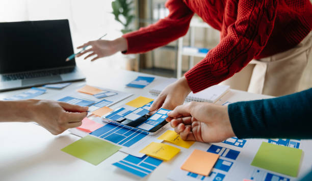 istock UI developer team brainstorming on their project with laptop, smartphone and digital tablet. Creative digital development agency. 1471363481