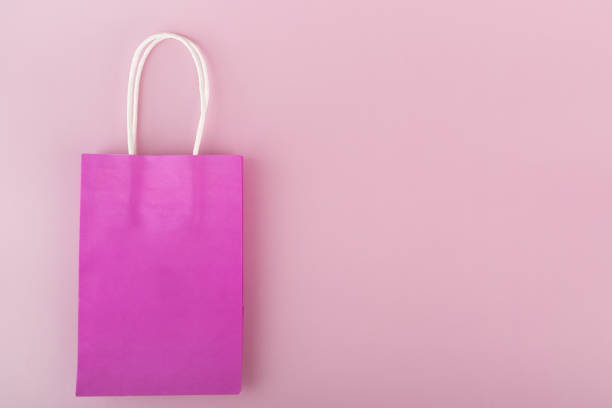 istock gift bag on a pink background, copy space, top view 1471364066