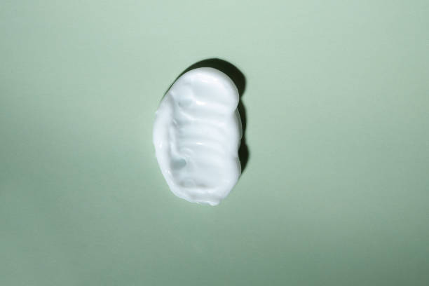 istock cream texture cosmetics, drop moisturizing hyaluronic cream, green natural background 1471364081