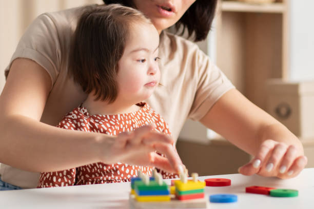 istock girl with down syndrome is distracted from learning 1471364119
