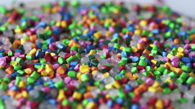 Multicolored Plastic granules. Polymer pellets. Polymeric dye. Colorant pellets.