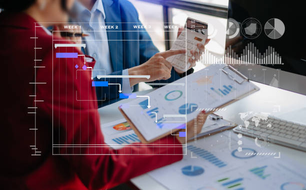 istock Businessman hand Project manager working and update tasks and Gantt chart scheduling virtual diagram.with smart phone, tablet and laptop 1471372155