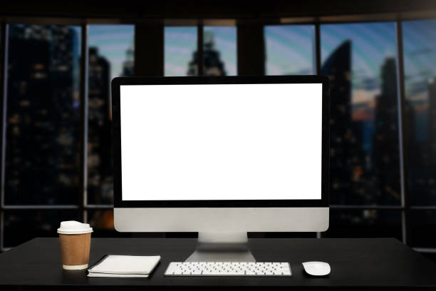 istock Workspace computer putting on wood working desk and surrounded by coffee cup, clipboard, potted plant, stack of smartphone, tablet, and keyboard  Orderly office. workspace concept. 1471372172