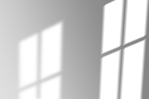 abstract shadow of the window in morning light on white wall texture blur background