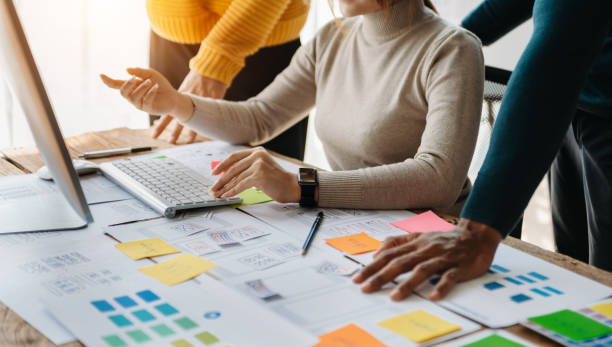 istock View of UI developer team brainstorming on their project with laptop, smartphone and digital tablet. Creative digital development agency. 1471372226