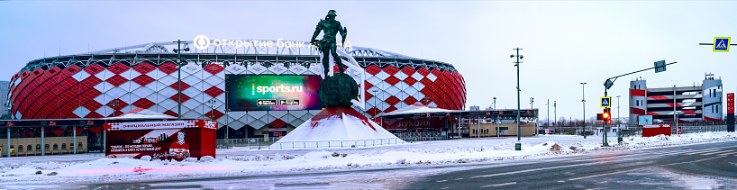 Moscow March 01 2023, Football stadium Spartak and sculpture of a gladiator on the square in front of the stadium, panoramic photo spring the beginning of the football season in Russia.
