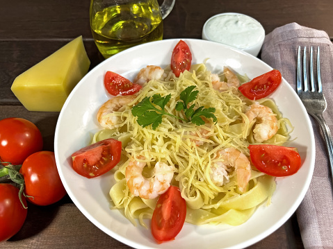 Pasta with shrimps, tomatoes and parmesan cheese. High quality photo