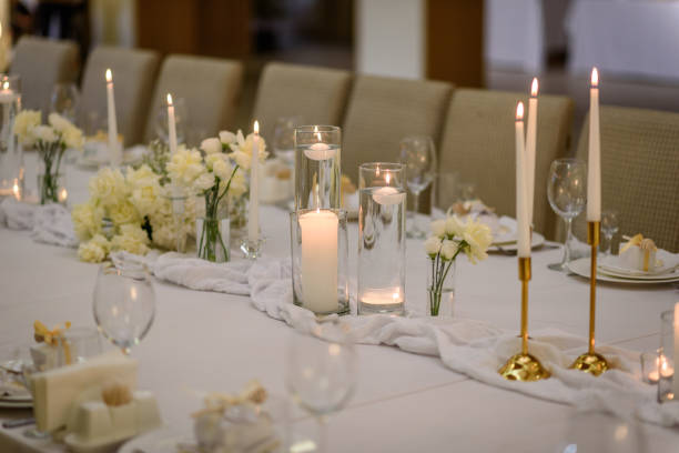 istock Festive table decorated composition flowers and candles in party area. Table setting, serving closeup. Wedding setup detail. Banquet decoration in hall restaurant. Luxury reception. 1471386659