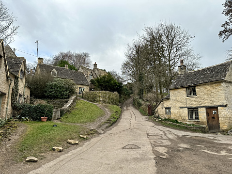 Arlington Row, Bibury, Cotswolds, England. Row of the historic quintessential Cotswold cottages in Bibury, Gloucestershire, England. Autumn or winter in English countryside
