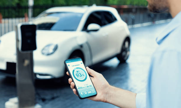 istock Closeup progressive idea hand holding smart phone display EV's batter status. 1471387078