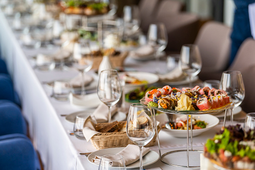 a table in a restaurant with dishes for a festive dinner and reception of guests