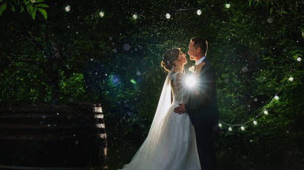 a bride and groom is dancing happily in the rain a bride and groom is dancing happily in the rain free wedding stock pictures, royalty-free photos & images