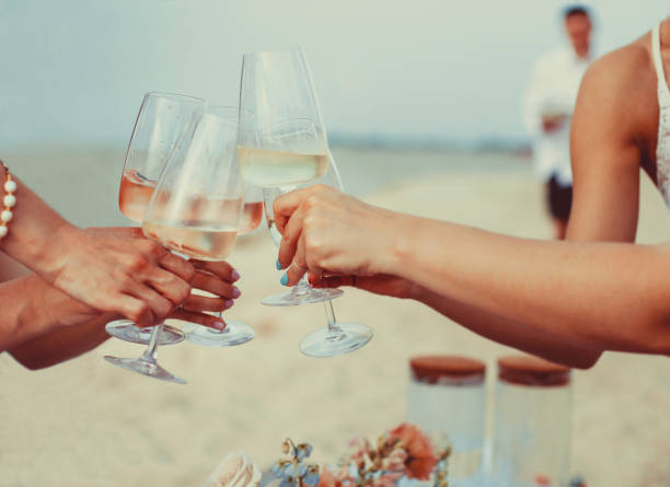 istock Cheerful women proposing toast on beach 1471394194