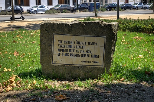 Coimbra, Portugal - August 15, 2022: Quotation in stone from Antonio Nobre in park (Parque da Cidade Manuel Braga) adjacent to Mondego River