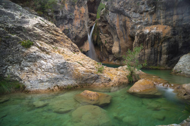 istock Crystal-clear river with long exposure, pool and orange-grey rocks 1471399810