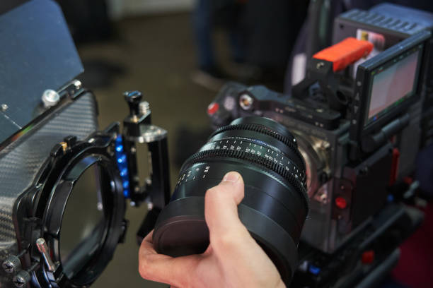 hand holding a professional movie camera lens