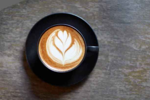 istock Coffee cup with cappuccino foam on wooden table. 1471404440