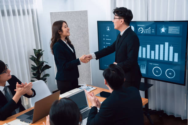 employees shake hand for symbol of harmony after successful business meeting. - 24201 imagens e fotografias de stock