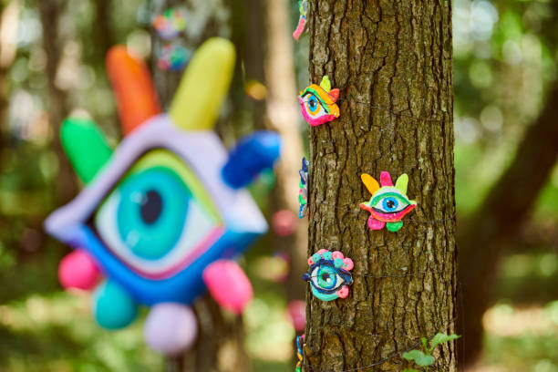 istock Art object of human eyes on tree trunk in green forest background, trees sight feeling ecological concept 1471405892