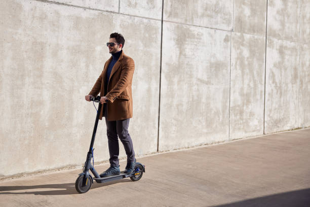 istock Handsome man commute to work on electric scooter 1471409016
