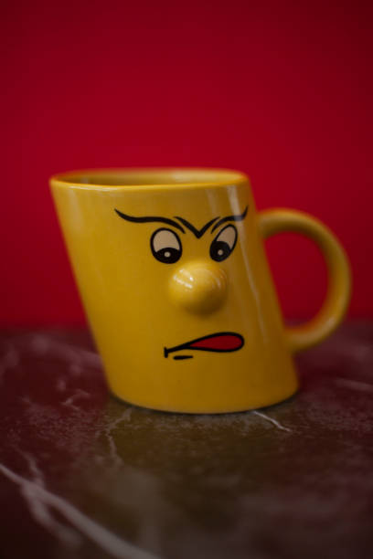 istock A yellow teacup with a face 1471410775