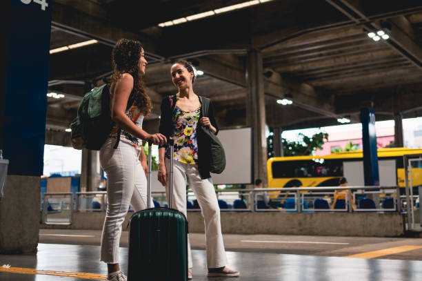 istock Two girlfriends at the bus station before the trip 1471410914