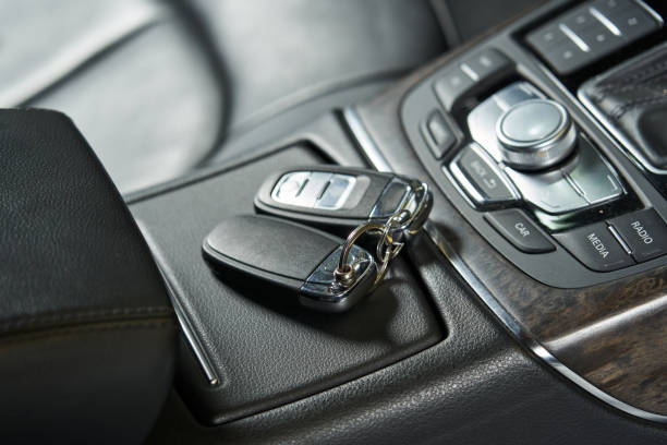 istock car keys lie on a closed glove box and an audio control unit 1471412544