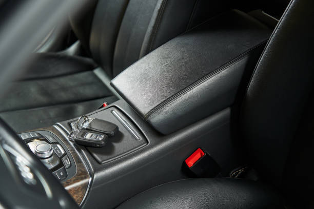 istock leather car armrest, keys lying on a hidden storage box 1471412734