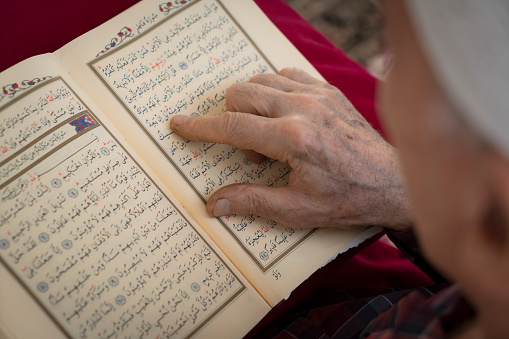 Muslim man who is reading Holy Quran