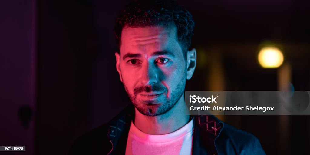 Portrait of a men in a futuristic cyberpunk style in neon clothes. A high-tech man