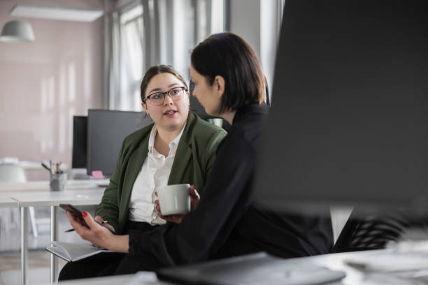istock Office female colleagues discussing at workplace 1471419885