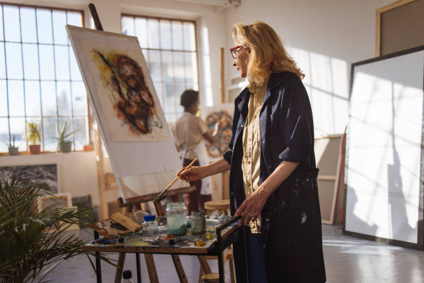Two women are painting stock photo