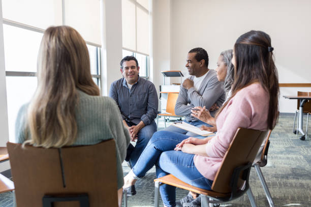 istock Diverse members of support group enjoy meeting together 1471421307